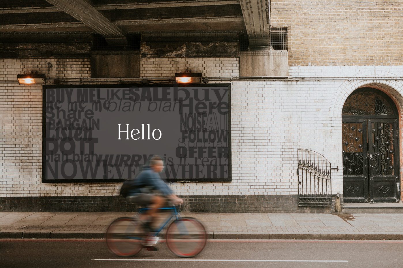 blurry man cycling past a street billboard with a clear white hello in the middle of other noisy dark words
